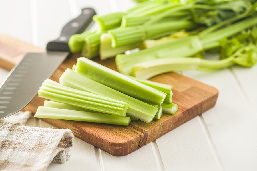 Cutting celery stalks on cutting board. © bigstockphoto.com / jirkaejc
